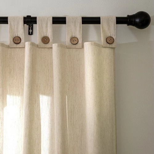 close-up of a tab-top curtain made of a smooth, solid-colored fabric, such as linen or cotton.