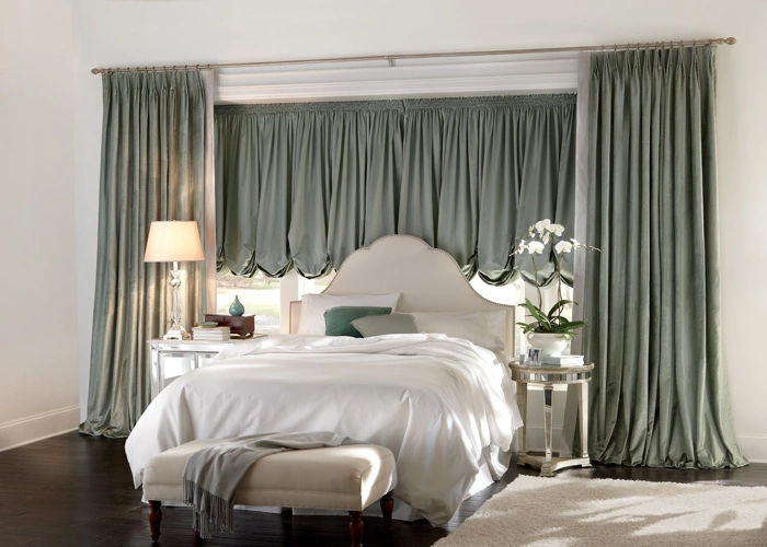 luxurious bedroom features a bed with white bedding placed in front of a window.