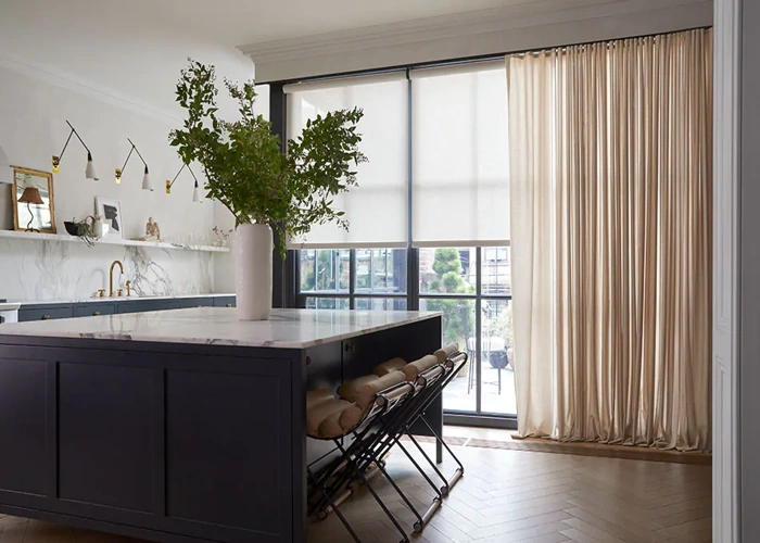 modern kitchen and dining area featuring a wall of windows covered by a multi-layered window treatment.